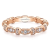 A 14k rose gold diamond stackable ring with 0.27 carats of diamonds.