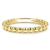 This 14k yellow gold stackable ring features beads.