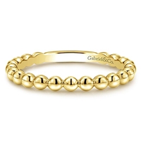 This 14k yellow gold stackable ring features beads.