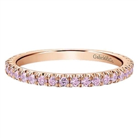 This 14k rose gold eternity stackable ring features pink stones.