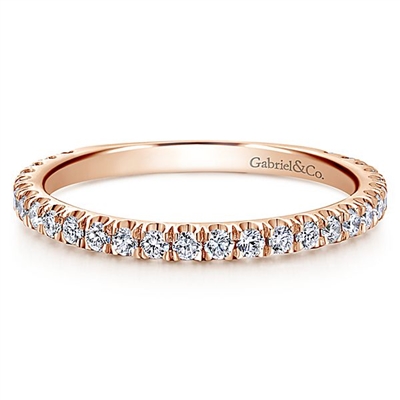 This 14k rose gold diamond stackable ring features a delicate row of shimmering diamonds that wrap around your finger.