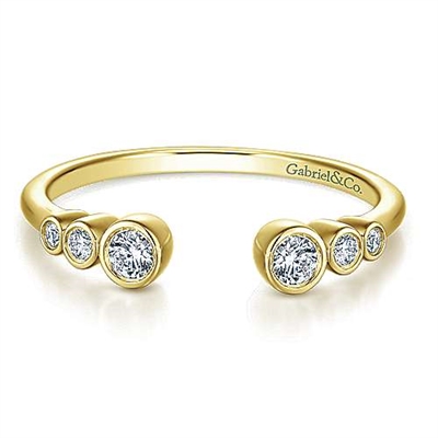 This 14k yellow gold diamond stackable ring features 6 round bezel set diamonds.