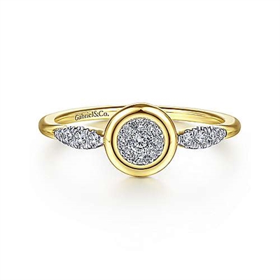 This 14k yellow gold diamond bezel ring features a cluster of shimmering diamonds.