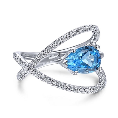 A 14k white gold diamond band with swiss blue topaz.