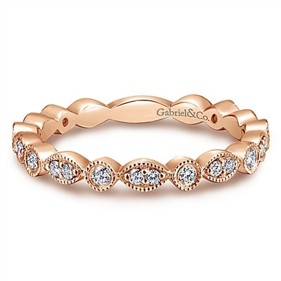 A 14k rose gold diamond stackable ring with a row of diamonds.