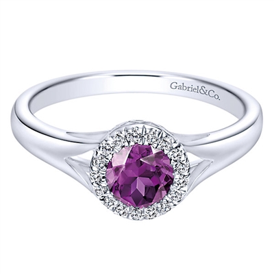 A gorgeous purple amethyst sits neatly in a halo of high quality round diamonds in this 14k white gold gemstone and diamond ring.