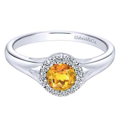 This 14k white gold citrine and diamond ring features round diamond accents in a halo, all in a petite and stylish design.