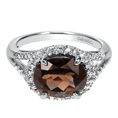 A 14k white gold diamond ring with one third carats of diamonds with a center smoky quartz.
