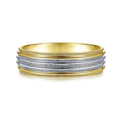 This 14k yellow and white gold men's wedding band features a milgrain channel and is 6 mm wide.