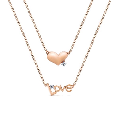 This 14k rose gold heart and love necklace features diamond accents.