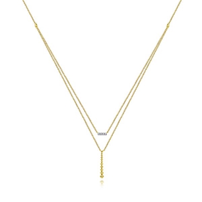 Two layered necklaces in one 14k yellow diamond bar necklace.