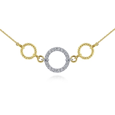 This 14k yellow and white gold diamond circle necklace features over one quarter carats of brilliant diamonds.