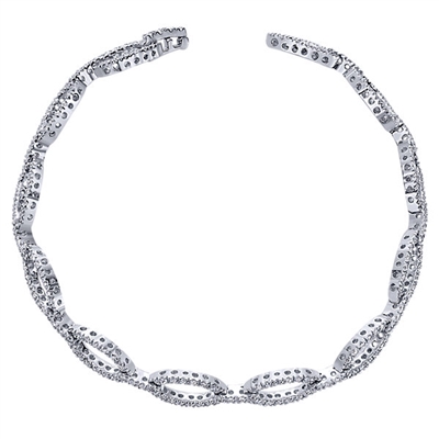 This stylish diamond tennis bracelet boasts nearly one and a quarter carats of round diamonds in oval sections spread throughout this opulent arm piece.