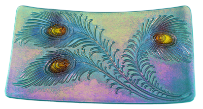 A rectangular dish made of iridescent glass. It has three large peacock feathers embossed on it that have been highlighted with shades of blue and purple. The eyes of each feather are yellow, and the base glass has a purple and green iridescent sheen.