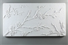 A long rectangular tile made of white ceramic. The carved texture has three delicate branches of cherry blossoms. One branch begins midway up the left edge, the largest branch begins from the bottom left, and another small branch is in the bottom right.