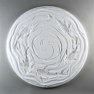 A circular tile made of white ceramic. The carved texture has a top-down view of five koi fish swimming around the outside. There are gentle waving lines surrounding the fish and coming together in a loose spiral in the otherwise empty center.