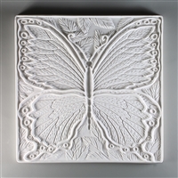A large square tile made of white ceramic. The carved texture is occupied primarily by a single large and detailed butterfly. There are a few leaves in the empty spaces around the butterfly, and a thin border around the entire tile.