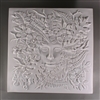 A large square tile made of white ceramic. The center of the carved texture shows a feminine face emerging from a cluster of leaves, flowers, and other foliage that occupy the rest of the tile.