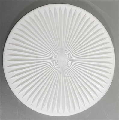 A large square tile made of white ceramic. The carved texture has multiple sharp lines all radiating from the center in a sunburst pattern.