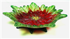 A footed glass dish. The dish itself is made from a frit cast poinsettia flower with yellow center and petals with bright red bases and light green tips. The feet of the dish are formed from dark green frit cast leaves.