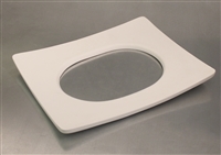 A rectangular white ceramic mold for fusing glass on a grey background. The edges curve very slightly upwards, and there is a large oval hole cut out of the middle.