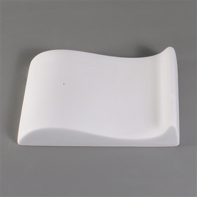 A rectangular white ceramic mold for fusing glass on a grey background. The mold has been carved into an S Curve shape.