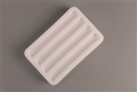 A rectangular white ceramic mold for fusing glass on a grey background. There are four identical evenly spaced rectangular cavities carved into it.