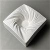 A tall square white ceramic mold for fusing glass on a grey background. There is a small flat circle carved deep into the very center. Many lines spiral clockwise like a cyclone into this flat center as the mold slopes inwards like a bowl.