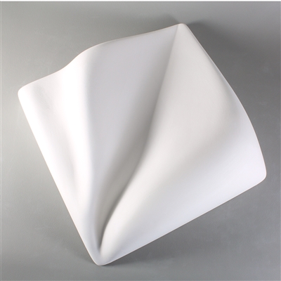 A square white ceramic mold for fusing glass on a grey background. The mold has been divided down a central diagonal with a gently waved line. The two halves are raised into organic triangular shapes.