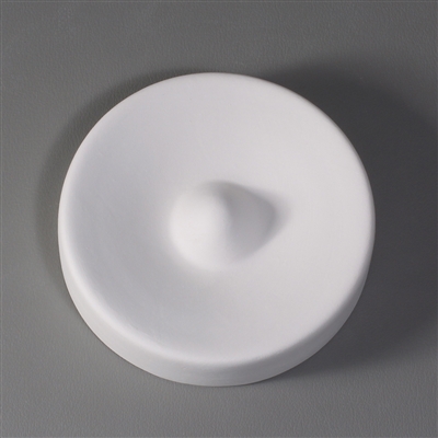 A circular white ceramic mold for fusing glass on a grey background. The very center of the mold has been raised into a small dome. The outside edges curve downwards and inwards slightly before reaching this center dome.