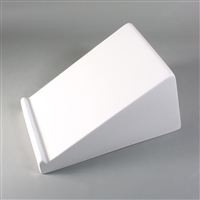 A wedge-shaped white ceramic mold for fusing glass on a grey background. The narrowest part of the wedge has a raised lip that goes along its entire length.