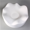 A circular white ceramic mold for fusing glass on a grey background. It is carved into a wide, gentle, waving shape around its outside, which slopes downwards into a flat circle in the very center.