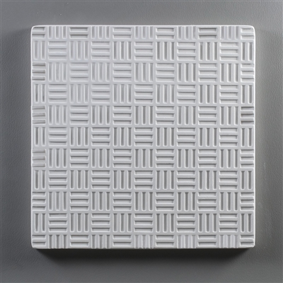 A square tile made of white ceramic for texturing hot glass. The tile has a repeating pattern of small squares, each consisting of three evenly spaced lines. The lines alternate between vertical and horizontal.