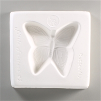A square, white ceramic mold for fusing hot glass on a grey background. A butterfly with detailed wings has been carved into it. The mold has Little Fritters Butterfly written around the butterfly in script.
