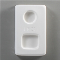 A rectangular white ceramic mold for fusing hot glass on a grey background. One small circle and one small square have been carved into it. The circle is above the square, and LF21 is carved in print between them.