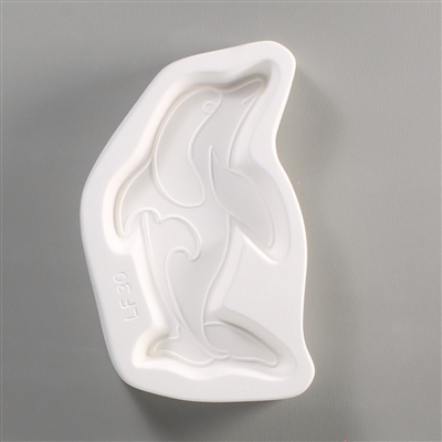A white ceramic mold for fusing hot glass on a grey background. A dolphin design with loose geometric patterns has been carved into it. The dolphin takes up most of the mold, but there is a small border of empty space around it. LF29 is carved next to it.