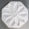 An octagonal, white ceramic mold for fusing hot glass on a grey background. A large, flat, detailed sunflower-like flower with ten petals has been carved into it. There is a small textured circle between the petals on the top right to make an extra center