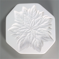 An octagonal, white ceramic mold for fusing hot glass on a grey background. A large detailed flat poinsettia flower has been carved into it.