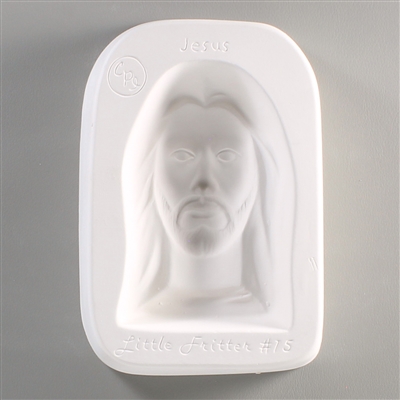 A rectangular white ceramic mold for fusing hot glass on a grey background. A simple portrait of Jesus has been carved into it. The mold has Little Fritters #15 Jesus engraved on the sides in script.