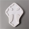 A cross-shaped white ceramic mold for fusing hot glass on a grey background. A large, simple cross has been carved into it.