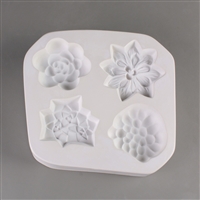 A square white ceramic mold for fusing hot glass on a grey background. Four detailed succulents have been carved into it. Each succulent has a different design similar to that of a real species, but all are similarly sized.