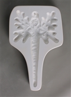 A T-shaped white ceramic mold for fusing hot glass on a grey background. A fairy holding a snowflake with snowflake wings and an elongated icicle body has been carved into it. There is a post above the head allowing for hanging after firing.