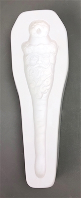 A long white ceramic mold for fusing hot glass on a grey background. A Santa face with a long beard tapering into an icicle has been carved into it. There is a post in the hat allowing for hanging after firing.