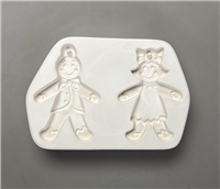 A white ceramic mold for fusing glass on a grey background with two gingerbread figures carved into it. The left figure has a jacket and tie and the right has a dress and bow. They have posts above their heads so they can be used to create ornaments.