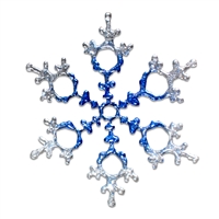 A delicate fused glass snowflake. The center of the snowflake begins blue and slowly fades outwards into white at the tip of each of the six arms.