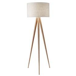 Director Modern Floor Lamp. The natural wood grain tripod legs are an angular counterpoint to the off-white textured drum shade.