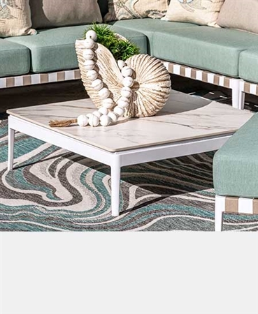 Modern outdoor coffee table with white frame and marble-look sintered stone top