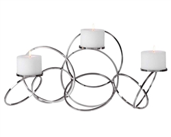 Kiernan Modern candleholder features an intertwined ring design and is finished in polished nickel. Three 4"x 3" white candles are included.