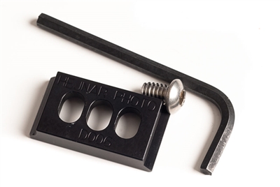 Arca-Swiss compatible 0.8 x 1.5 inch camera plate with three mounting slots and no ridge.