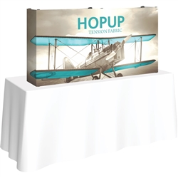 5ft Straight HopUp 2x1 Tabletop Fabric Trade Show Display with Full Fitted Graphic has a light weight, heavy duty frame that holds a fabric graphic mural. It sets up in seconds and can be packed away just as quickly after trade show or event
